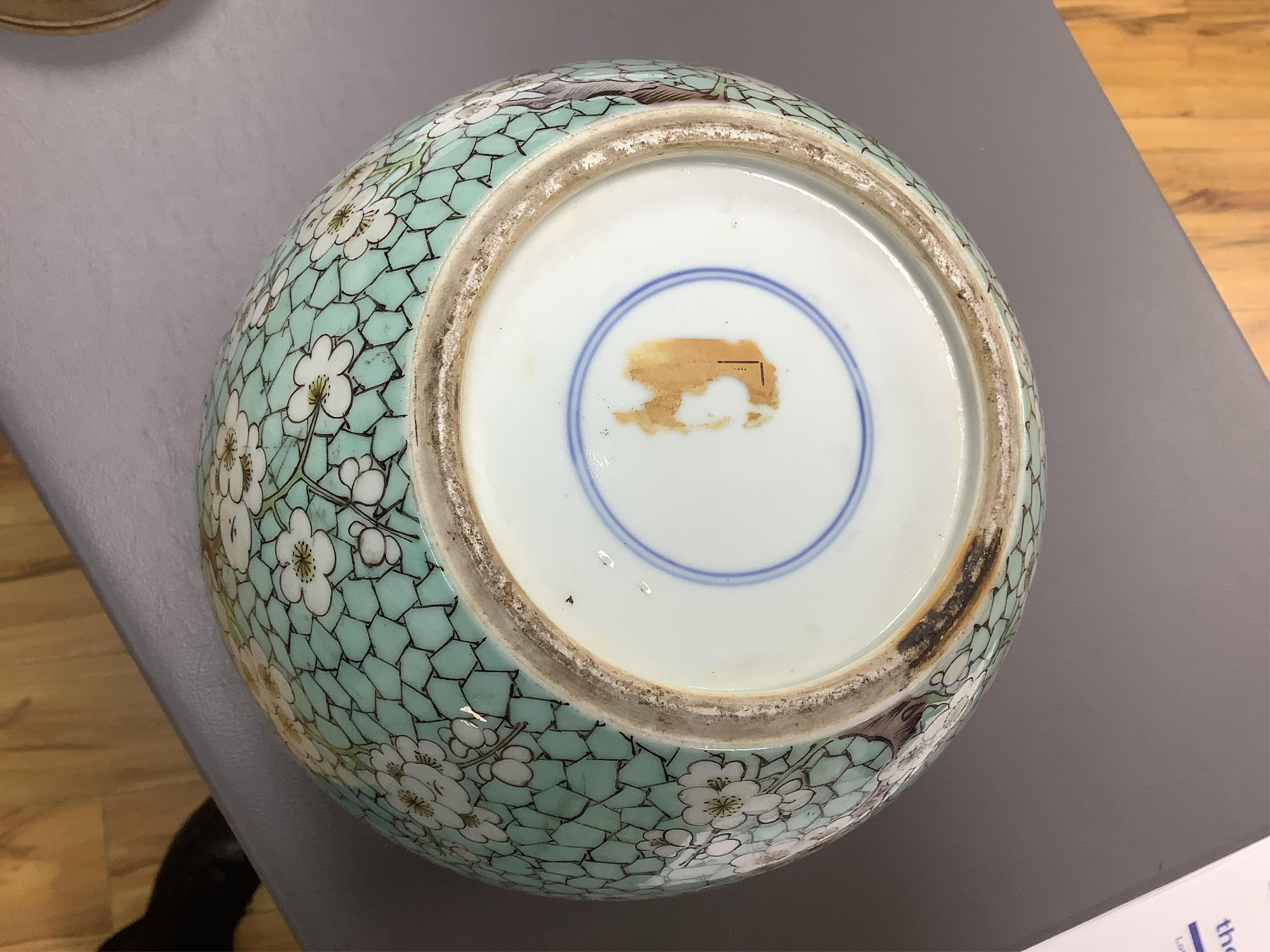 A Chinese famille verte enamelled prunus jar, 19th century, with wood cover and stand, 25cm high